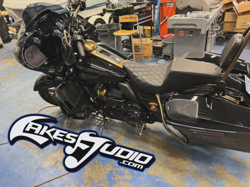Harley-Davidson Street Glide A black motorcycle parked in a workshop with tools and equipment in the background.