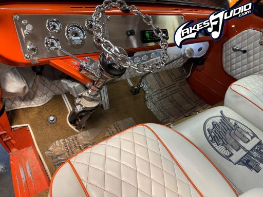 Ford Econoline Interior of a vintage car featuring orange accents, chrome details, and distinctive seat upholstery.