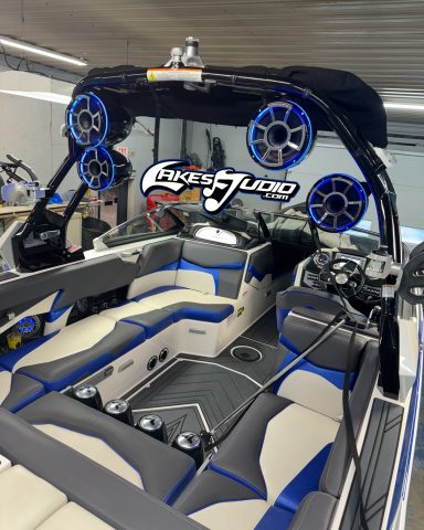 Supra Boat Interior of a sleek boat with blue and gray upholstery and four speakers mounted overhead.