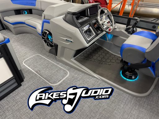South Bay Pontoon Interior of a modern boat with gray and blue seating and console, featuring glowing accents.