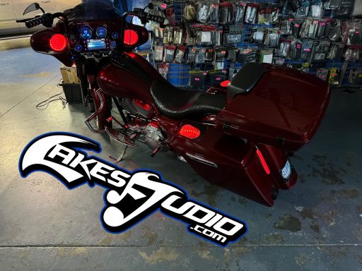 Harley-Davidson Street Glide A red motorcycle parked in a workshop with various tools and parts visible in the background.